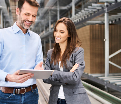 man and woman looking at a tablet
